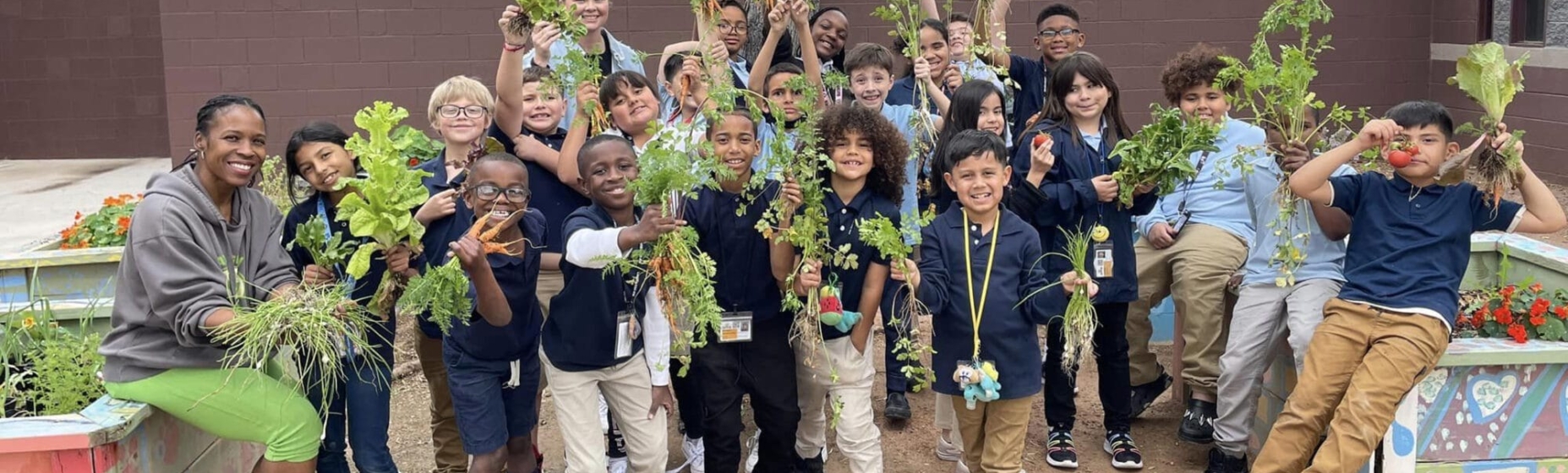 Kids holding up herbs