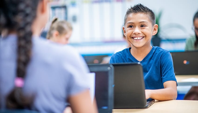 student smiling on computer