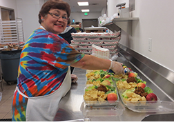 Cafeteria worker preparing food