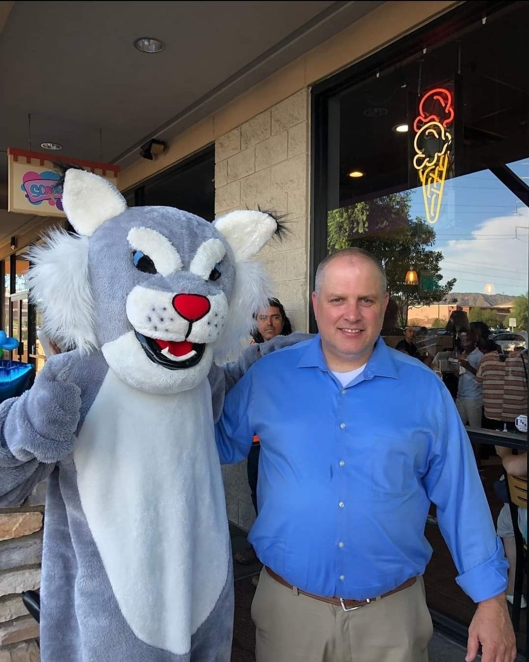 Teacher posing with mascot